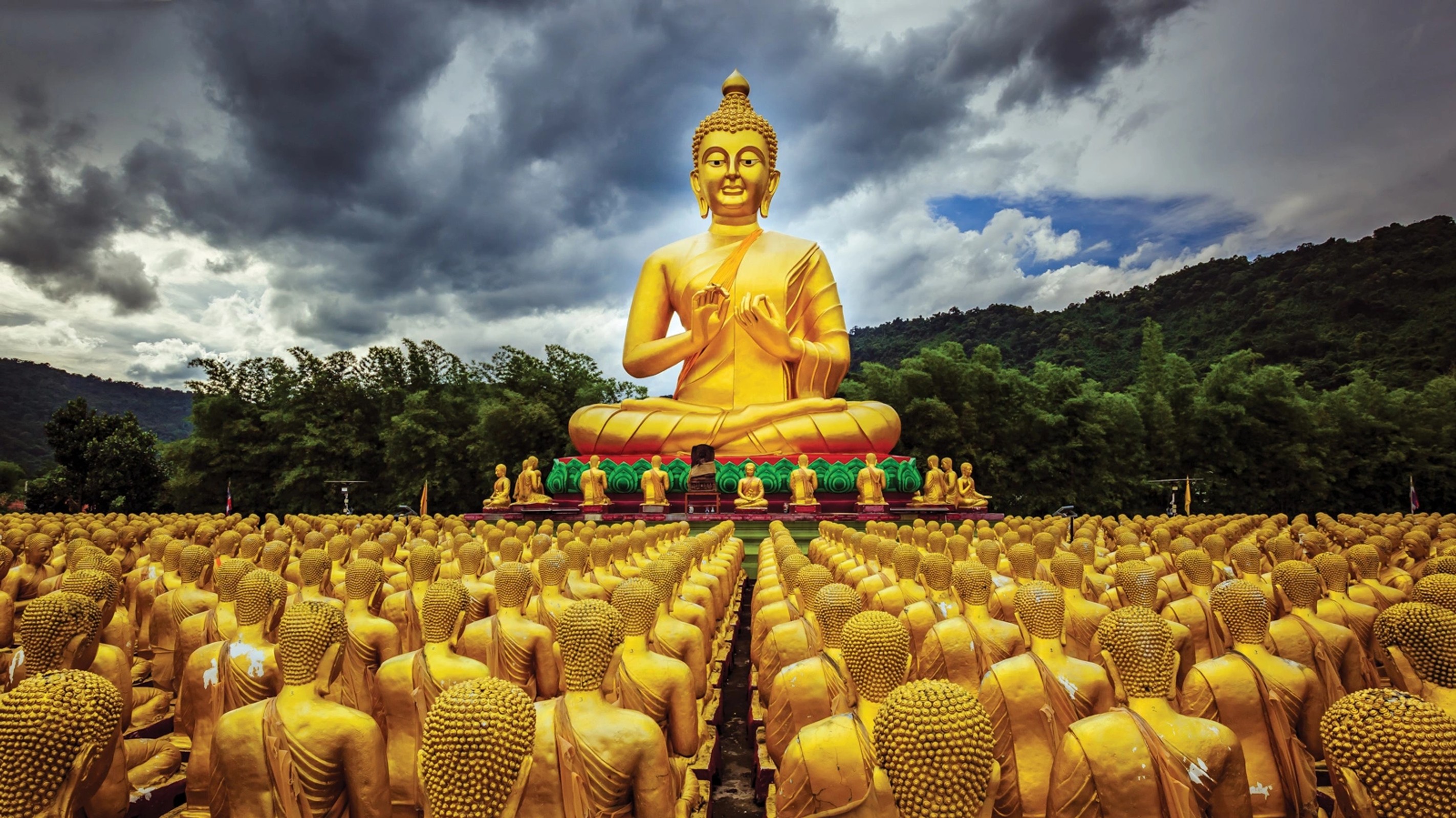 A golden Buddha under an open sky