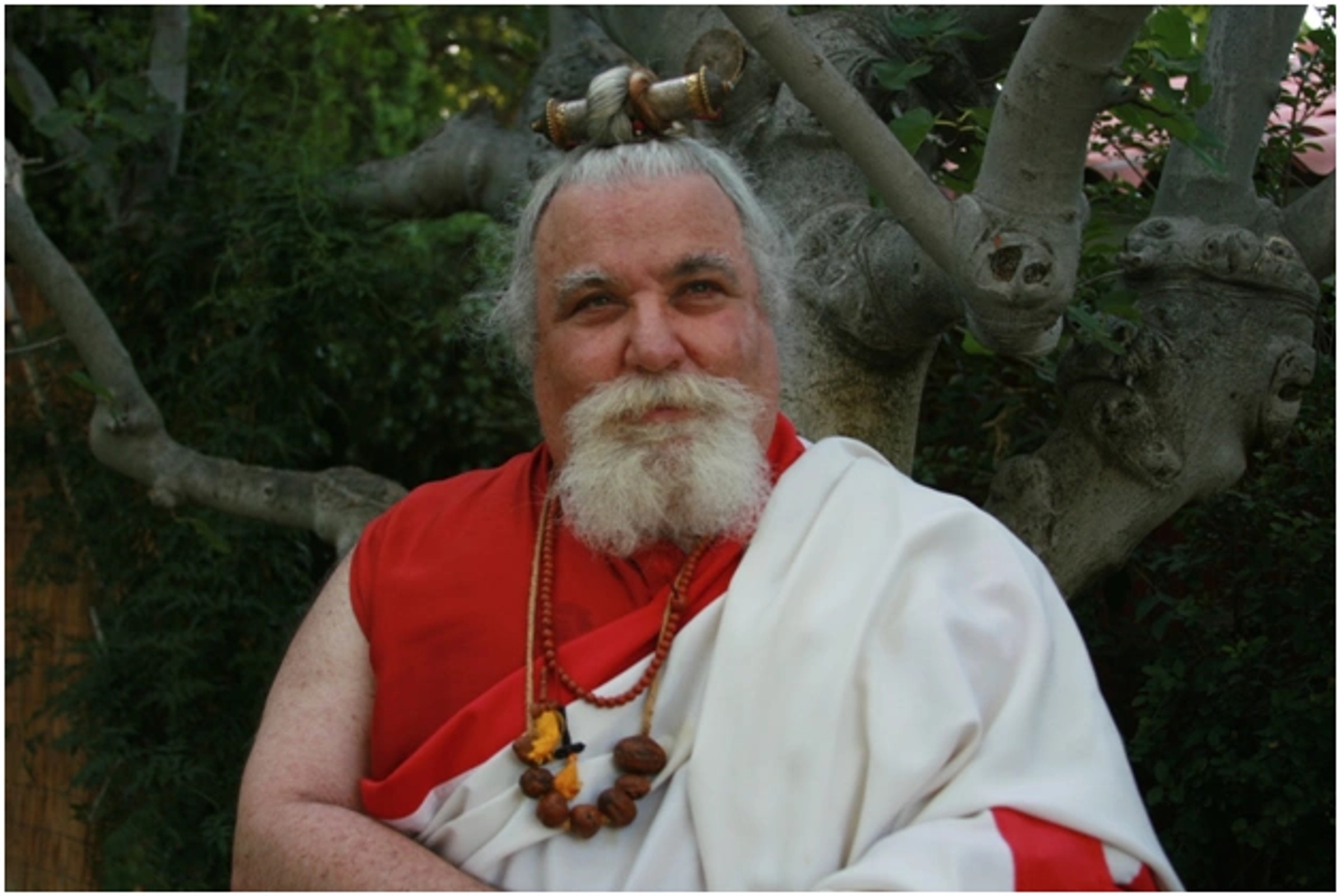 Ngakchang Karma Yeshe Namgyal Dorje Rinpoche in the white and red robes of a ngakpa