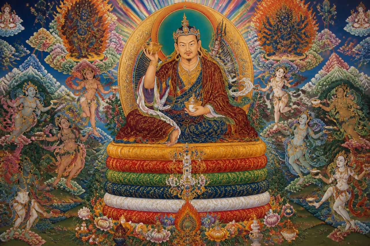 An illustration of Guru Padmasambhava on a throne of cushions, dakinis making offerings around him